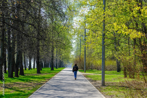 Lonely woman walking in the spring park