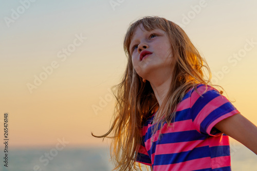 blond long-haired girl on sunset background