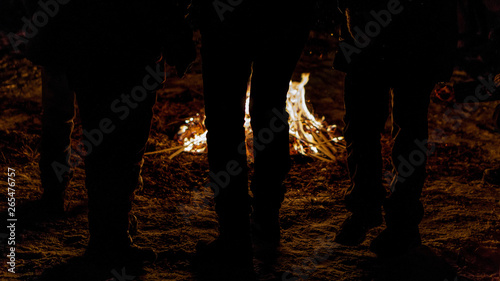 people around the fire at night