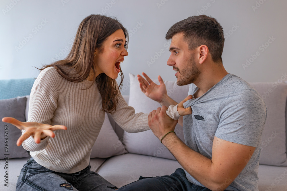 Furious couple arguing while having problems in their relationship. Stop annoying me! Angry woman arguing with her husband at home. Couple Having Argument At Home Stock Photo | Adobe Stock