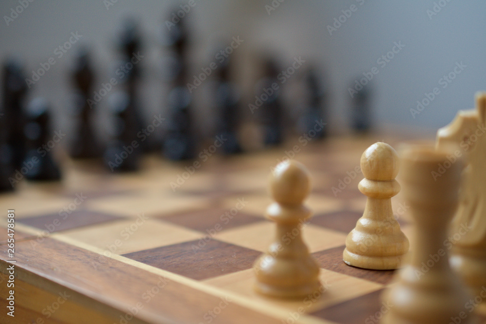 A corner-view of the chess board. the pawn is the piece in focus, the other are blurry. A corner-view of the chess board. the pawn is the piece in focus, the other are blurry.