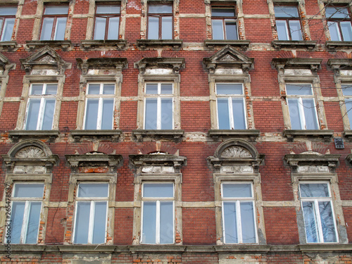 Old house facade non renovated with red bricks in germany © Sinuswelle