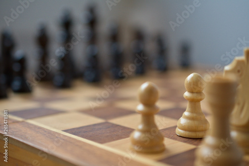 A corner-view of the chess board. the pawn is the piece in focus  the other are blurry.
