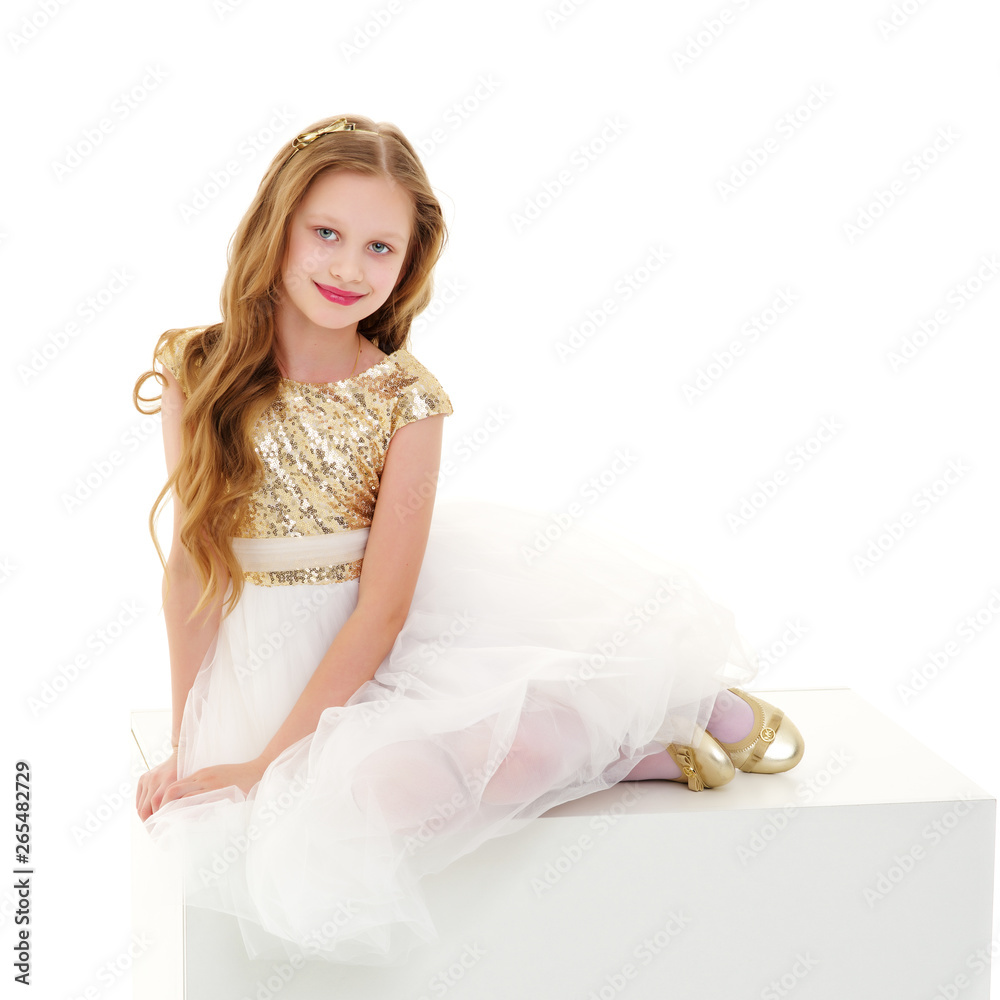 The little girl is sitting on a white banner. The little girl is sitting on a white banner.