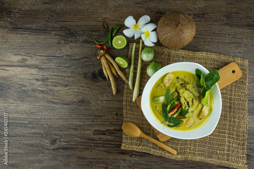 fish ball Green curry with coconut curry  (Kaeng kheiyw hwan) on dark wooden background with Thai tradition food served with steamed rice. Thai food very popular photo