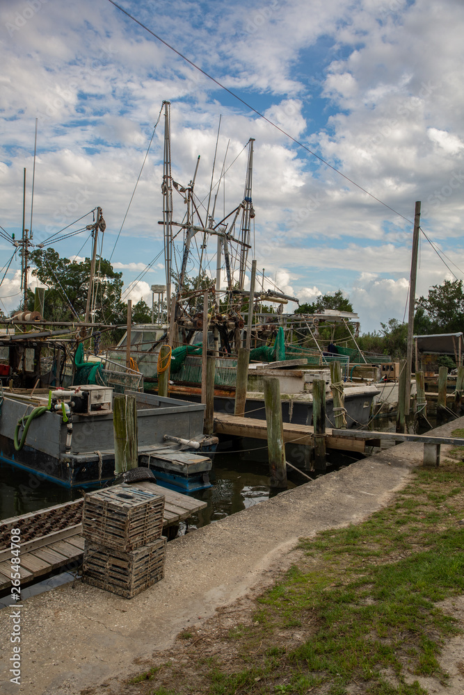 Shrimping boats docked along river in Florida.