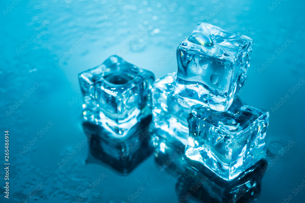 ice cubes wet with water drops on blue background ice cubes wet with water drops on blue background