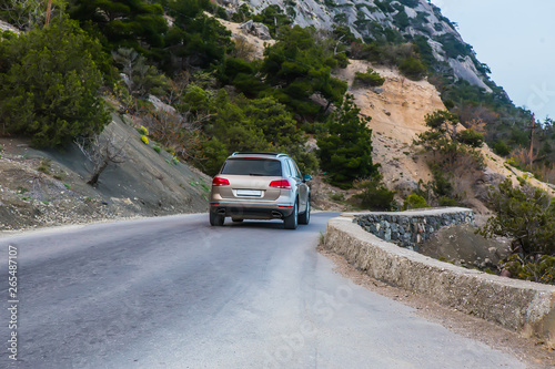 Car Moves along a winding road in the mountains during