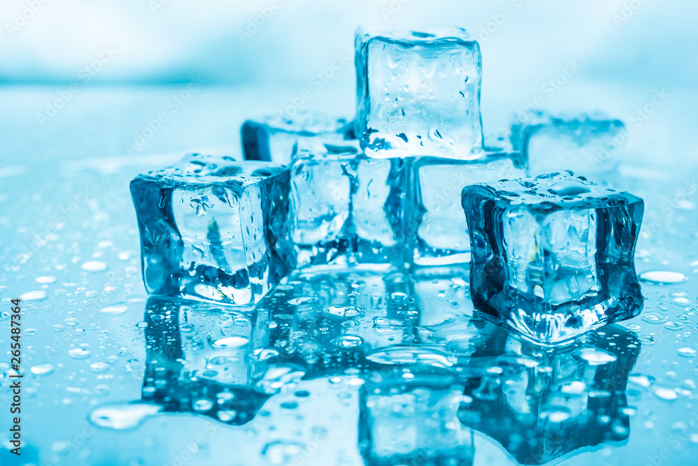 ice cubes wet with water drops on blue background