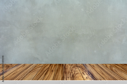 Wooden table on cement wall background.