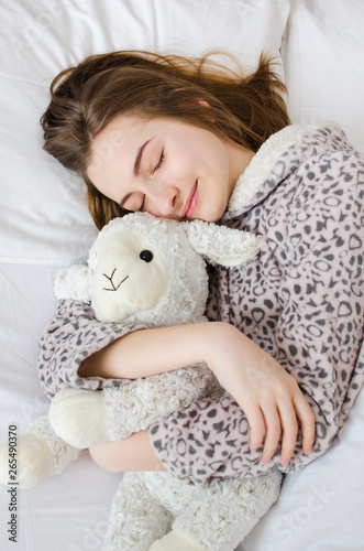 Teen girl sleeping with toy