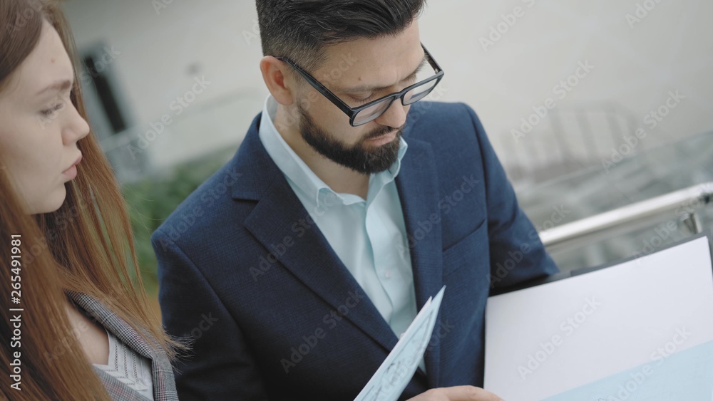 Business meeting men and women: discuss and study documents, standing ...
