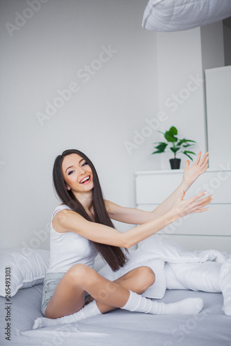 Relaxing On Bed During Weekend. Beautiful Woman Relaxing on a Bed and Looking Happy