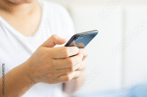 Man holding and use smartphone on hand. subject is blurred.