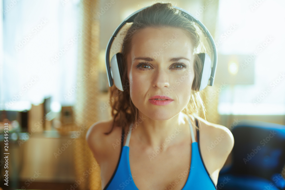 Naklejka premium woman listening to music with headphones and stretching