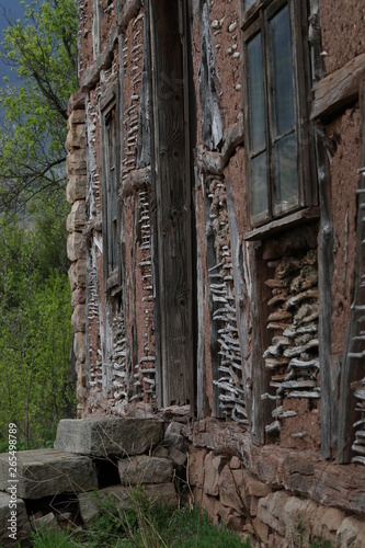 Old ruined house adobe and wood facade in village Gara Bov, Bulgaria. Old adobe wall. Brown, detail.