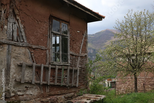 Old ruined house adobe and wood facade in village Gara Bov, Bulgaria. Old adobe wall. Brown, detail.