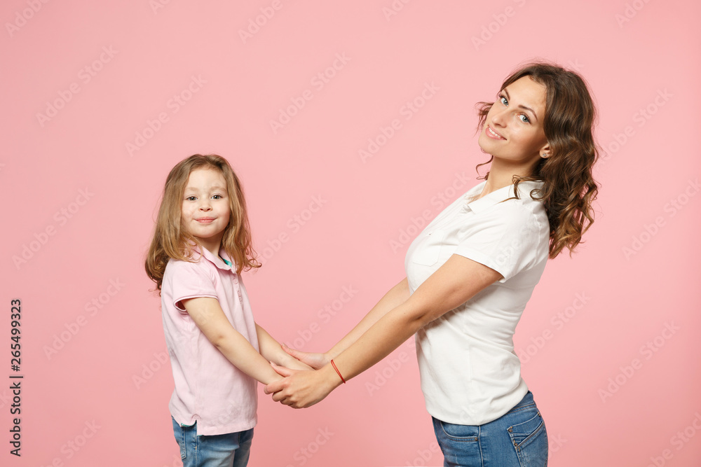 Woman in light clothes have fun with cute child baby girl. Mother, little kid daughter isolated on pastel pink wall background, studio portrait. Mother's Day, love family, parenthood childhood concept Woman in light clothes have fun with cute child baby girl. Mother, little kid daughter isolated on pastel pink wall background, studio portrait. Mother's Day, love family, parenthood childhood concept