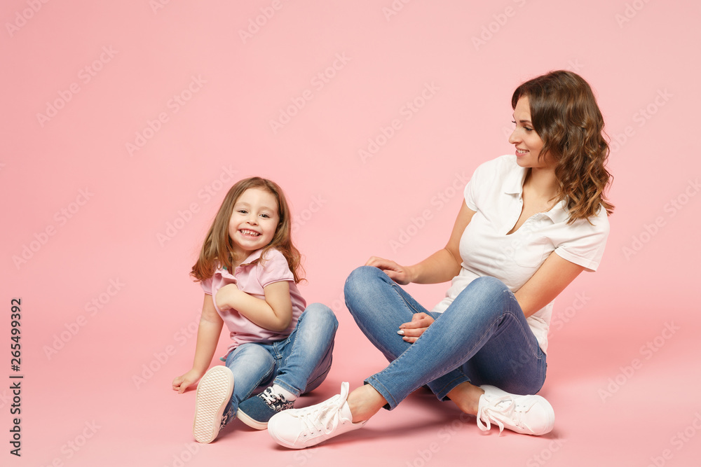 Woman in light clothes have fun with cute child baby girl. Mother, little kid daughter isolated on pastel pink wall background, studio portrait. Mother's Day, love family, parenthood childhood concept Woman in light clothes have fun with cute child baby girl. Mother, little kid daughter isolated on pastel pink wall background, studio portrait. Mother's Day, love family, parenthood childhood concept