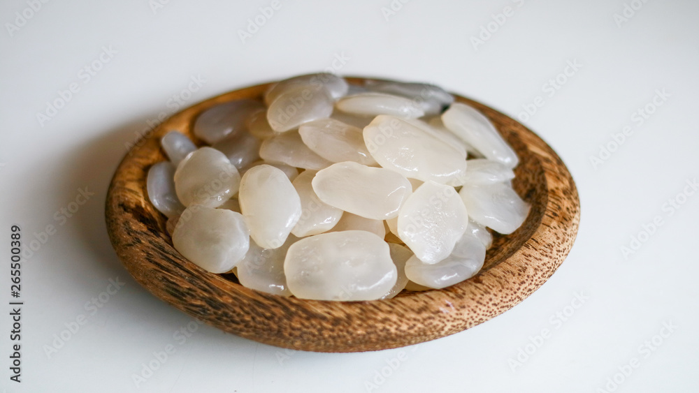 Sugar palm fruit on wooden plate on white background. Sugar palm fruit on wooden plate on white background.