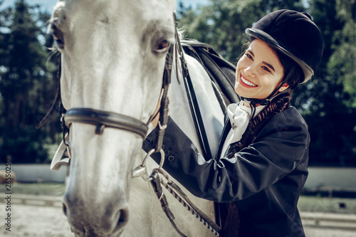 Positive nice woman being together with her horse