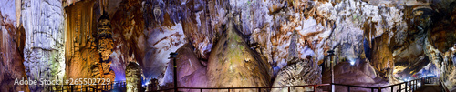 Amazing geological forms in Paradise Cave near Phong Nha, Vietnam. Panoramic piucture of limestone cave full of stalactites and stalagmites.