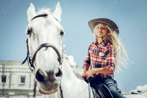 Cute long haired girl learning how to ride