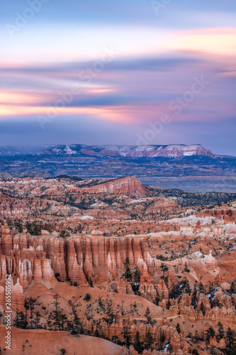 Beautiful soft pastel colors in a sunset sky over Bryce Canyon National Park. Unique natural rock formations and hoodoos in the popular southwest location. 