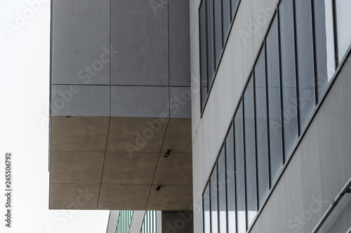 fragment of gray concrete building with empty windows