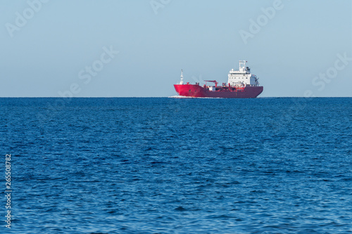 red cargo barge at sea