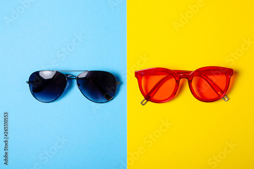 Sunglasses fashion style on yellow blue background, top view