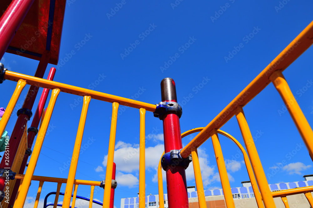 a fragment of a children's playground against a bright blue sky