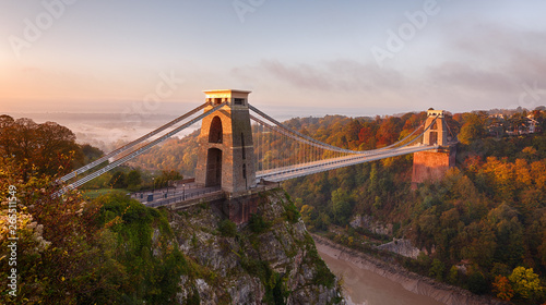 Clifton Suspension Bridge on an autumn morning as the sun rises and breaks through the clouds photo