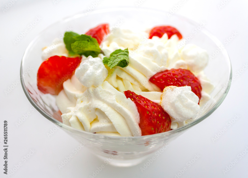 juicy strawberries with cream in a transparent glass bowl on a white background side view juicy strawberries with cream in a transparent glass bowl on a white background side view