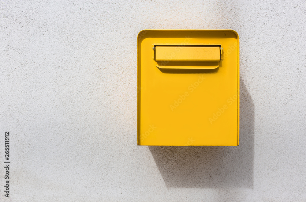 Yellow mailbox on white wall. Retro style Yellow mailbox on white wall. Retro style