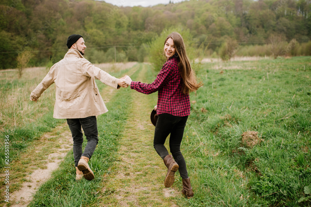 Happy couple walking on the nature at the mountains