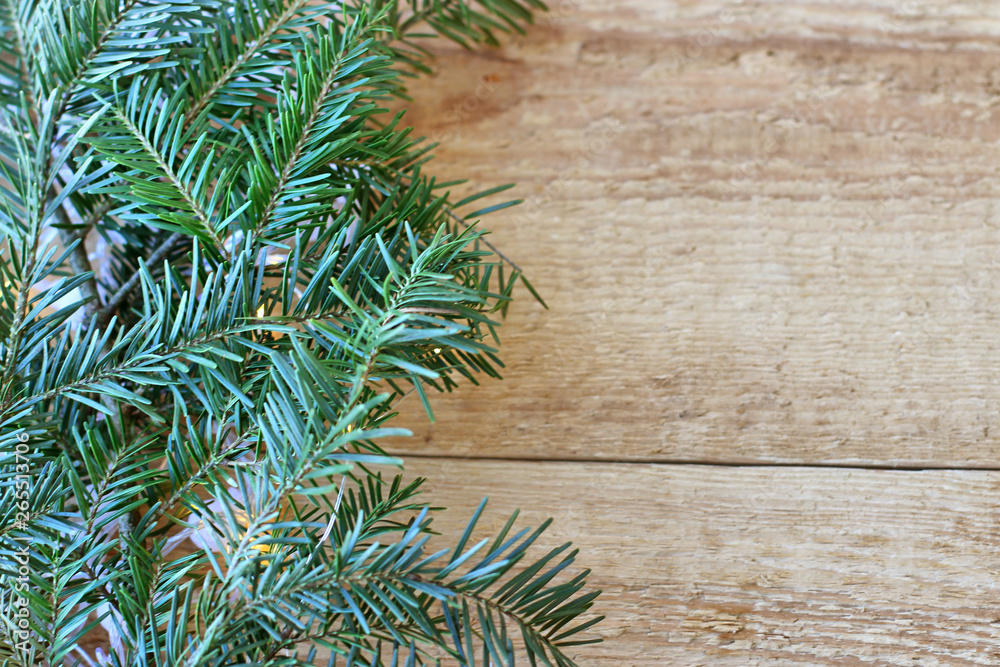 Christmas decorations - branches of coniferous trees with decorations on a wooden background. Christmas decorations - branches of coniferous trees with decorations on a wooden background.