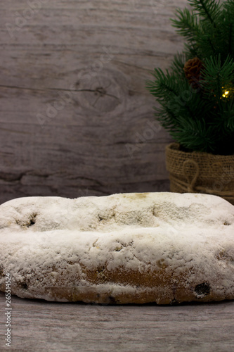 Stollen (traditional German Christmas cake) on wooden background