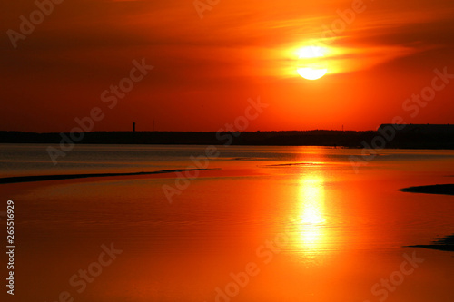 Beautiful orange sunset on the Baltic sea with solar track on the water