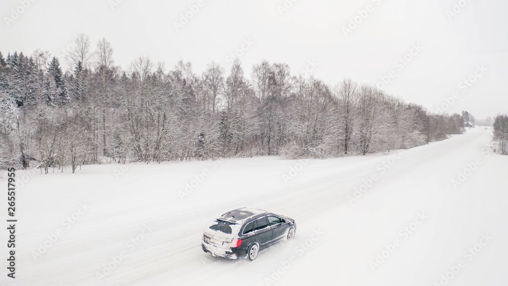 22590_The_aerial_view_of_the_car_on_the_snow_white_road42.jpg