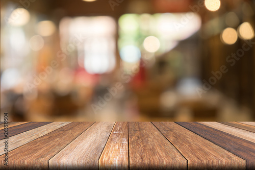 Empty wooden table of brwon in front Warm orange color of bokeh on wooden background