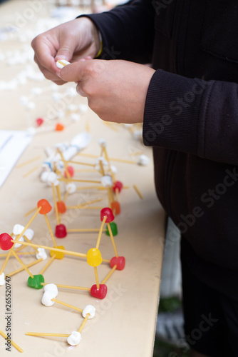 Field trip to the University of Washington Engineering days, structural engineering experiment build a bridge detail close up with hands building