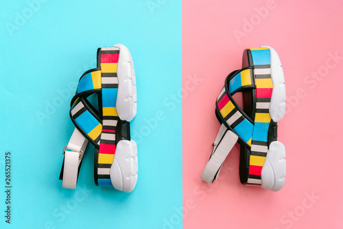 Set of fashionable female shoes. Summer trendy multicolored womens sandals on high wedge on blue and pink background. Voguish and stylish footwear for conident modern girls.