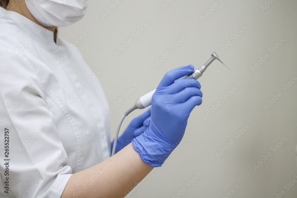 dental endodontics instruments in the hand of a blue glove in the background of dentistry. dental endodontics instruments in the hand of a blue glove in the background of dentistry.