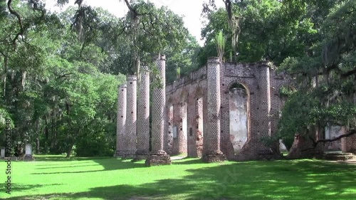 The Pillars of Old Sheldon Church Ruins in Beaufort County, North Carolina with Green Grass and Trees photo