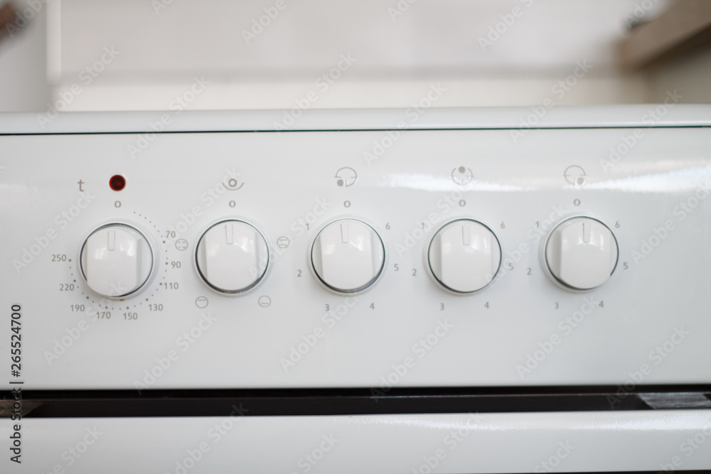 electric cooker kitchen knobs close-up white electric cooker kitchen knobs close-up white