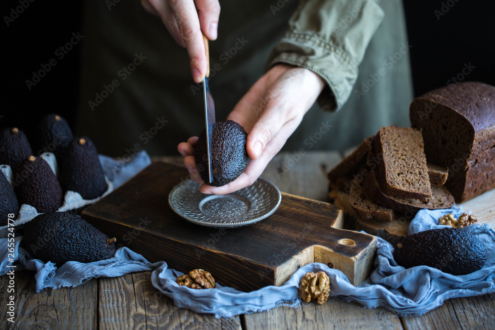 Fototapeta premium Avocado on black bread with nuts 