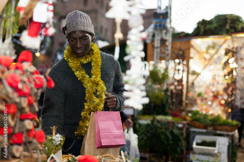 Guy choosing Christmas decorations