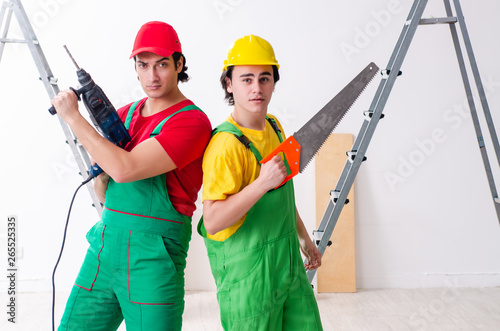 Two workers contractors working indoors   photo