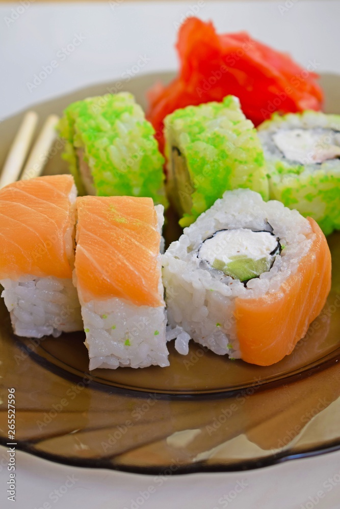 Delicious mouth-watering rolls on a glass plate.Sushi. Delicious mouth-watering rolls on a glass plate.Sushi.